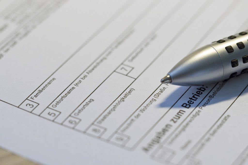 A picture of a pen resting on top of a form.