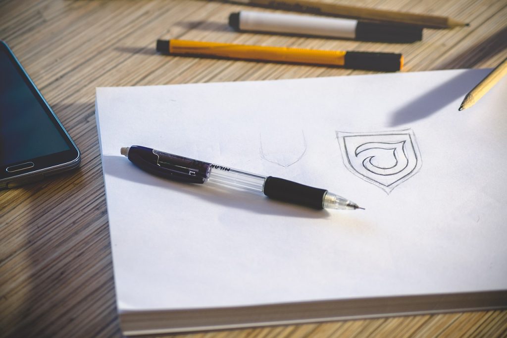 A picture of a pencil and a "J" logo design.